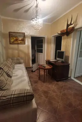 a living room with a couch and a desk with a computer at Montenegrin vintage house in Mojanovići