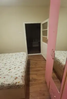 two beds in a room with a door open at Montenegrin vintage house in Mojanovići