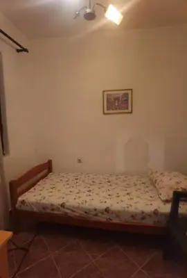 a bedroom with a bed and a picture on the wall at Montenegrin vintage house in Mojanovići