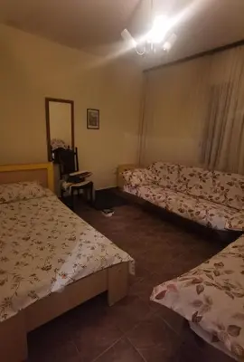 a room with two beds and a mirror at Montenegrin vintage house in Mojanovići