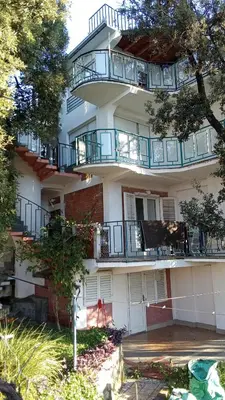 a large building with balconies on the side of it at Apartmani Primorski hrast in Bar