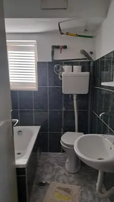 a bathroom with a toilet and a sink at Apartmani Primorski hrast in Bar
