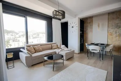a living room with a couch and a table at Luxury 1-Bedroom close to the beach in Rafailovici in Rafailovici