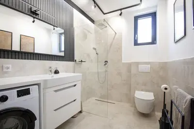 a bathroom with a shower and a toilet and a sink at Luxury 1-Bedroom close to the beach in Rafailovici in Rafailovici