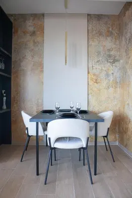 a dining room with a black table and white chairs at Luxury 1-Bedroom close to the beach in Rafailovici in Rafailovici