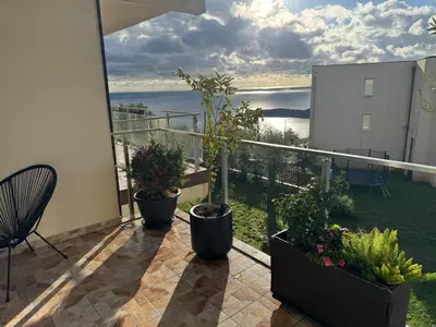 a balcony with potted plants and a view of the water at Maximus in Seoca