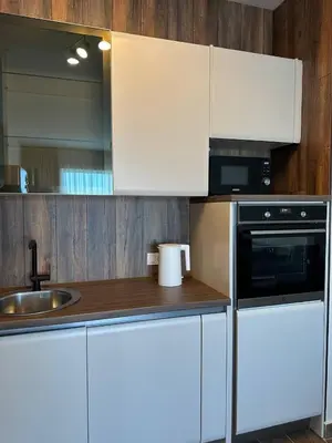a kitchen with white cabinets and a sink at Maximus in Seoca