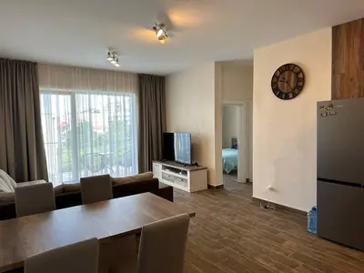 a living room with a table and a television at Maximus in Seoca