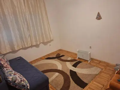a living room with a couch and a rug at Guest house PG in Podgorica
