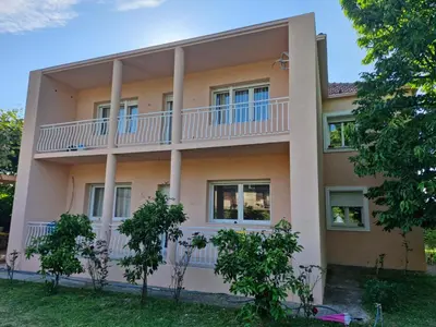 a building with a balcony on the side of it at Guest house PG in Podgorica