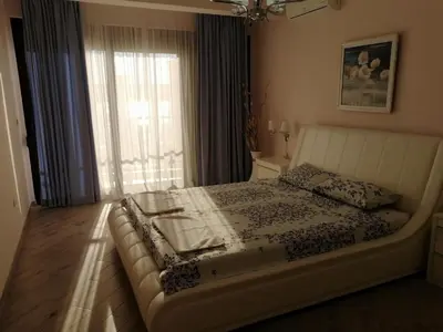 a bedroom with a bed with a large window at Sun&Sea Apartments in Dobra Voda