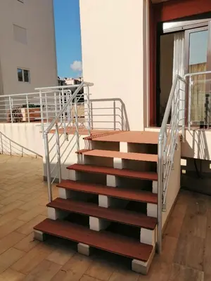 a stairway in a building with a railing at Sun&Sea Apartments in Dobra Voda