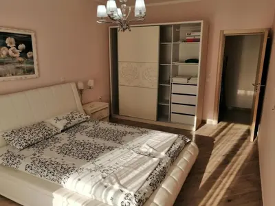 a bedroom with a bed and a large mirror at Sun&Sea Apartments in Dobra Voda
