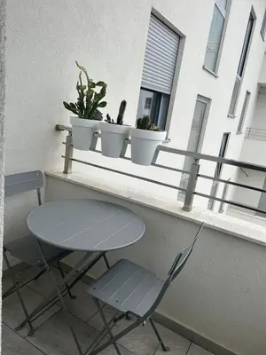 a table and two chairs on a window sill at Apartment Cactus in Ulcinj