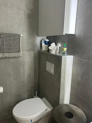 a bathroom with a white toilet and a sink at Apartment Cactus in Ulcinj