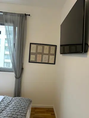 a bedroom with a flat screen tv on the wall at Apartment Cactus in Ulcinj