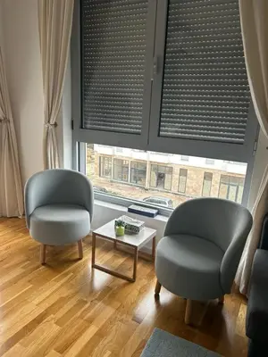 two chairs and a coffee table in front of a window at Apartment Cactus in Ulcinj