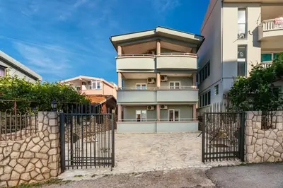 an apartment building with a gate in front of it at Sea House Apartments in Bar