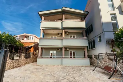 an apartment building with balconies and a fence at Sea House Apartments in Bar