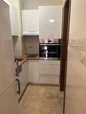 a kitchen with a stove and a microwave at Central Podgorica Suite in Podgorica