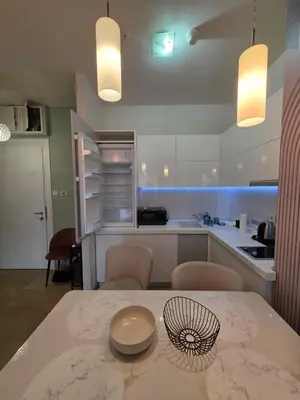 a kitchen with a table with a bowl on it at Orenda Residences- Sea View Apartment in Budva