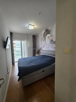 a bedroom with a bed with a painting on the wall at Orenda Residences- Sea View Apartment in Budva