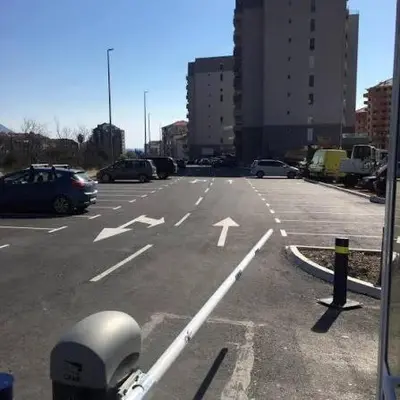 an empty parking lot with cars parked in a city at Budva apartment in Budva