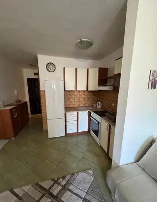 a kitchen with a white refrigerator in a room at Budva apartment in Budva
