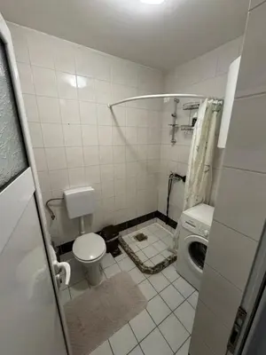 a bathroom with a toilet and a washing machine at Budva apartment in Budva