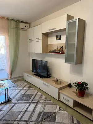 a living room with a flat screen tv and a living room at Budva apartment in Budva