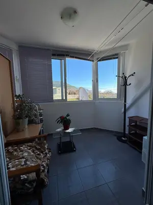 a living room with a couch and a table and windows at Budva apartment in Budva