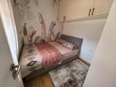 a small bedroom with a bed in a room at relaxroom Podgorica in Podgorica