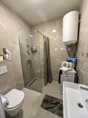 a bathroom with a shower and a toilet and a sink at relaxroom Podgorica in Podgorica