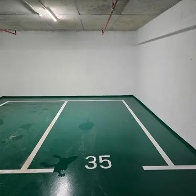 an empty gymnasium with a green basketball court at Premium apartments with garage in Podgorica