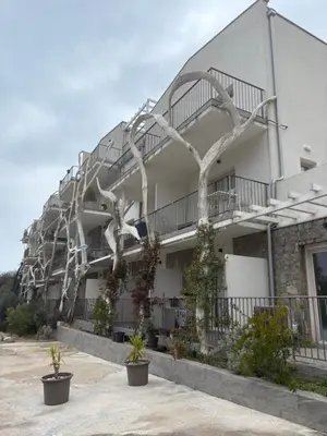 a building with a spiral staircase on the side of it at Val Apartment, Przno in Budva