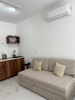 a living room with a couch and a kitchen at Val Apartment, Przno in Budva