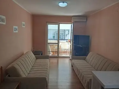 a living room with two couches in a room at Квартира in Budva