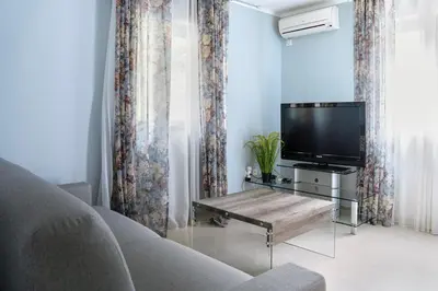 a living room with a tv and a couch at Green Garden Villa in Becici