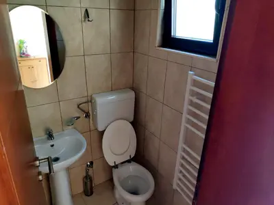 a small bathroom with a toilet and a sink at Apartment Rade - free parking in Budva