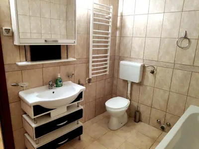 a small bathroom with a sink and a toilet at Apartment Rade - free parking in Budva