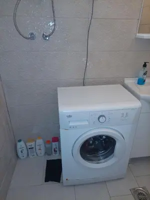 a washing machine in a bathroom next to a sink at Podgorica apartment in Podgorica