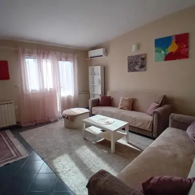 a living room with a couch and a table at Podgorica apartment in Podgorica