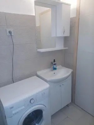 a bathroom with a washing machine and a sink at Podgorica apartment in Podgorica