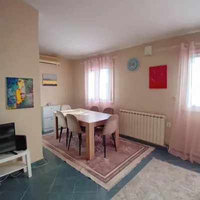 a dining room with a table and chairs at Podgorica apartment in Podgorica