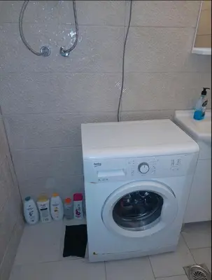 a washing machine in the corner of a bathroom at Podgorica apartment in Podgorica