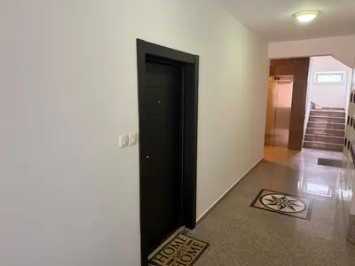 a black door in a hallway with a tile floor at KAZOSA Sea Apartment in Becici