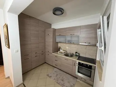a small kitchen with a sink and a refrigerator at KAZOSA Sea Apartment in Becici