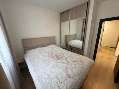 a bedroom with a bed and a large mirror at KAZOSA Sea Apartment in Becici
