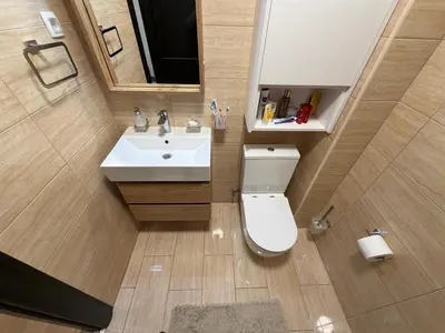 a bathroom with a white toilet and a sink at KAZOSA Sea Apartment in Becici