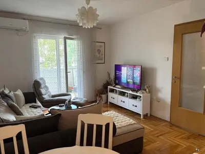 a living room with a couch and a tv at LuxeStay Ksenija apartment in Podgorica